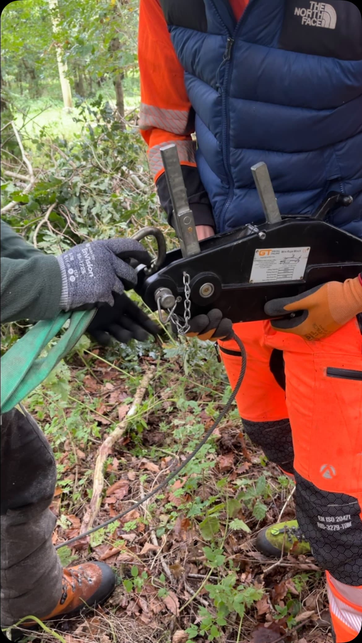 Close view of hands checking chainsaw equipment